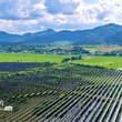 Glistening atop the water at a solar-fishery farm, blue photovoltaic panels soa…