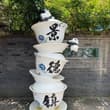 熊猫戏瓷碗，闲游景德镇。青花落笔，烧制出流淌千年的东方美学。 Pandas play atop giant porcelain bowls in Jingde…