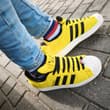 ⚡💛 Pikachu meets striped socks! 🧦👟 Yellow Pokémon sneakers + colorful socks = t…
